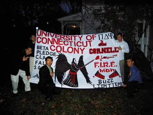 Brothers holding the Beta Colony pledge class banner